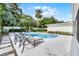 Inviting backyard pool area with comfortable lounge chairs, surrounded by lush landscaping and mature trees at 2109 Montana St, Orlando, FL 32803
