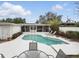 A backyard pool area features a screened lanai, white concrete patio and lounging area at 2109 Montana St, Orlando, FL 32803