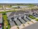 Aerial view of new townhomes with driveways and green spaces and pond at 2224 Tay Wes Dr, St Cloud, FL 34771