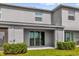 Rear view of the home with sliding glass doors and a covered patio at 2224 Tay Wes Dr, St Cloud, FL 34771
