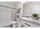 This bathroom features a tub shower, sleek white cabinets with black pulls, and neutral countertops at 2224 Tay Wes Dr, St Cloud, FL 34771