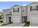 Inviting townhome featuring a gray exterior, attached garage, and well-maintained landscaping at 2224 Tay Wes Dr, St Cloud, FL 34771