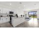 Well-lit kitchen boasting white cabinets, modern appliances, and an adjacent living area at 2224 Tay Wes Dr, St Cloud, FL 34771