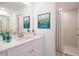 This modern bathroom features a neutral color palette, quartz countertop and walk-in shower with tiled walls at 2260 Suanne Ave, Eustis, FL 32726