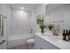 Bright bathroom featuring a tub shower with white subway tile and vanity with stylish fixtures at 2260 Suanne Ave, Eustis, FL 32726