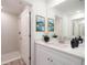 Modern bathroom features a walk-in shower, bright white cabinetry, quartz countertop and stylish decorative accents at 2260 Suanne Ave, Eustis, FL 32726