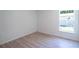 Neutral bedroom featuring a large window providing natural light and luxury vinyl plank flooring at 2260 Suanne Ave, Eustis, FL 32726