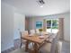 Bright dining area with a window and wood table, complemented by stylish chairs at 2260 Suanne Ave, Eustis, FL 32726