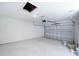 A well lit garage featuring new concrete flooring and a working garage door at 2260 Suanne Ave, Eustis, FL 32726