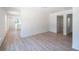 Open-concept living space with hardwood floors connecting to kitchen and hallways at 2260 Suanne Ave, Eustis, FL 32726