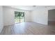 Spacious living room with luxury vinyl plank flooring and sliding glass doors offering backyard views at 2260 Suanne Ave, Eustis, FL 32726