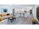 Open-concept home with living room flowing into the eat-in kitchen and breakfast bar seating at 2260 Suanne Ave, Eustis, FL 32726