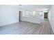 Open-concept living space with luxury vinyl plank flooring that connects the living and kitchen area at 2260 Suanne Ave, Eustis, FL 32726