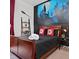 Themed bedroom with a full-sized bed, dark wood accents, and a large decorative mural at 236 Boxwood Dr, Davenport, FL 33837