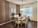 Elegant dining room with wood floors and a modern chandelier at 236 Boxwood Dr, Davenport, FL 33837