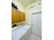 Functional laundry room featuring side by side washer and dryer and ample storage at 236 Boxwood Dr, Davenport, FL 33837