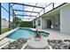 Sparkling pool with a screened-in lanai and lounge chairs at 236 Boxwood Dr, Davenport, FL 33837
