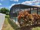 Screened in pool surrounded by lush tropical plants creating a private outdoor retreat at 236 Boxwood Dr, Davenport, FL 33837