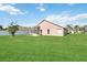 Expansive backyard features lush lawn and screened-in patio for outdoor enjoyment at 2481 Deer Creek Blvd, St Cloud, FL 34772