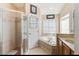 Clean bathroom with a glass shower, corner tub, and vanity with storage for a relaxing spa experience at 2481 Deer Creek Blvd, St Cloud, FL 34772