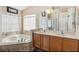 Bright bathroom includes a soaking tub, glass shower, double sinks, and vanity for added convenience at 2481 Deer Creek Blvd, St Cloud, FL 34772