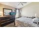 Bedroom features carpeted floors, a ceiling fan, and a comfortable bed with decorative bedding at 2481 Deer Creek Blvd, St Cloud, FL 34772