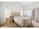 Bedroom with carpeted floors, a ceiling fan, and a comfortable bed with floral patterned bedding at 2481 Deer Creek Blvd, St Cloud, FL 34772