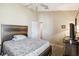 Bedroom with carpeted floors, a ceiling fan, and a comfortable bed with patterned bedding at 2481 Deer Creek Blvd, St Cloud, FL 34772