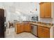 Well-lit kitchen with granite countertops and stainless steel appliances overlooks the living area at 2481 Deer Creek Blvd, St Cloud, FL 34772