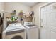 Laundry room featuring a washing machine, a dryer, storage shelving, and a closed door at 2481 Deer Creek Blvd, St Cloud, FL 34772