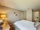 Bedroom with a queen bed, side table with lamp, white walls, and bathroom view at 2641 Hemingway Ave, Haines City, FL 33844