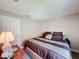 Bedroom with a queen bed, side table with lamp, and white doors at 2641 Hemingway Ave, Haines City, FL 33844