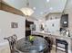 Eat-in kitchen features modern light fixture and island with barstool seating at 2641 Hemingway Ave, Haines City, FL 33844