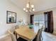 Traditional dining room featuring a chandelier, decorative mirror, and neutral color palette at 2641 Hemingway Ave, Haines City, FL 33844