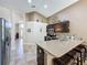 Open kitchen featuring a large island with bar stool seating and dark wood cabinetry at 2641 Hemingway Ave, Haines City, FL 33844
