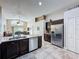 Bright kitchen with stainless steel appliances, tile flooring and an island with sink at 2641 Hemingway Ave, Haines City, FL 33844