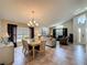 Open floor plan featuring a dining table and living room with tile flooring and vaulted ceilings at 2641 Hemingway Ave, Haines City, FL 33844