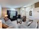 Bright living room with sofas, a glass coffee table, and arch windows showcasing natural light at 2641 Hemingway Ave, Haines City, FL 33844