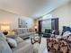 Comfortable living room with neutral decor, sofas, a glass coffee table, and natural light at 2641 Hemingway Ave, Haines City, FL 33844