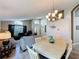 Open-concept living area with dining table, sofas, and bright natural light from the windows at 2641 Hemingway Ave, Haines City, FL 33844