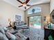 Open living room with comfortable seating and views of screened-in pool and patio at 2641 Hemingway Ave, Haines City, FL 33844