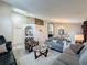 Comfortable living room with neutral decor, arched wall design element, and adjacent dining area at 2641 Hemingway Ave, Haines City, FL 33844