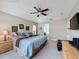 A spacious bedroom with a king bed, dresser and ensuite access to the bathroom at 2641 Hemingway Ave, Haines City, FL 33844