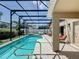 Inviting screened-in pool area with poolside seating, perfect for relaxation and entertaining with covered patio at 2641 Hemingway Ave, Haines City, FL 33844