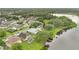 A neighborhood with a lake and docks is shown from above, surrounded by lush greenery and trees at 2658 Adele Pl, Lake Mary, FL 32746