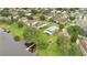 An aerial view showcases a neighborhood home with lake access, featuring a private dock and lush landscaping at 2658 Adele Pl, Lake Mary, FL 32746