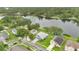 An aerial view shows a home near a lake with a dock, nestled in a neighborhood with mature trees at 2658 Adele Pl, Lake Mary, FL 32746