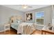 Cozy bedroom with a unique headboard, wood floors, and ample natural light at 2658 Adele Pl, Lake Mary, FL 32746