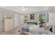 Bright bedroom features natural light, neutral decor, and sleek hardwood floors at 2658 Adele Pl, Lake Mary, FL 32746