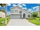 Charming two-story home with a well-manicured lawn, beautiful landscaping, and a blue front door at 2658 Adele Pl, Lake Mary, FL 32746